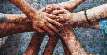 Close up top view of young people putting their hands together. Friends with stack of hands showing unity.